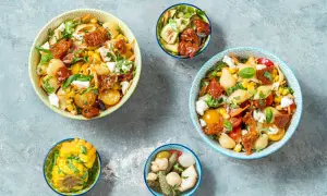 Insalate di pasta con pomodorini gialli, mais e feta, perfette per ricette primi estive.